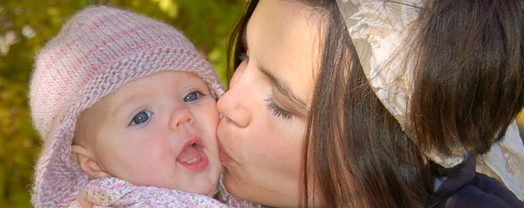 Mother kissing her child