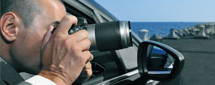 Investigator taking a picture from his car window